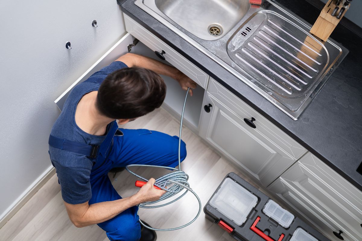 Plumber Cleaning Clogged Drain